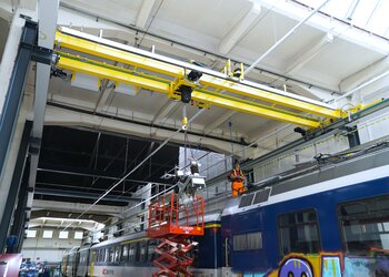 Overhead travelling crane with electric chain hoist over railway wagon