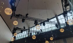 Electric chain hoists carry trusses with lighting