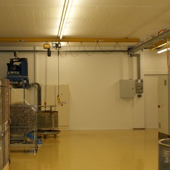 A modern electric chain hoist, is electrically mobile and suspended from a crane runway