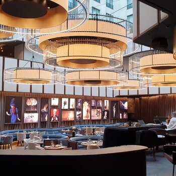 Lighting in Hotel Atrium In the entrance area of the hotel, electric chain hoists hold the large lamps.