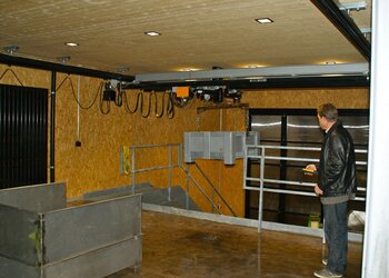 A plastic container is gently lifted by the GIS electric chain hoist and transported from the ground floor to the stage on the ground floor.