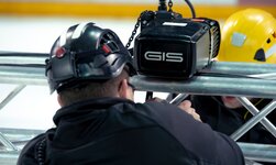 Climbing hoist is attached to truss, which is then equipped with loudspeaker and spotlight