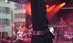 Loudspeaker systems are attached to a chain hoist