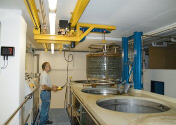 In very tight spaces, a container is moved with a crane system