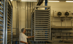 Rust-resistant crane lifts rack with cheese from salt bath in cheese dairy