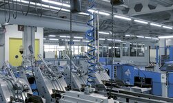 In a printing plant, rolls of paper are lifted with a synchronous chain hoist