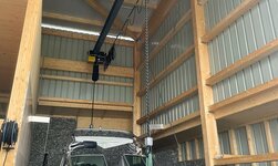 Electric chain hoist lifts boat from ship's trailer