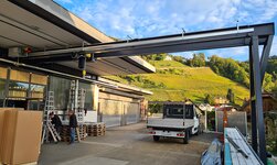 A gantry crane is used in the forecourt of the workshop for handling goods