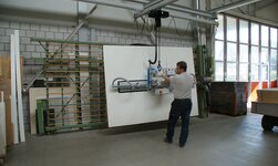 Vacuum lifter lifts and turns wooden board